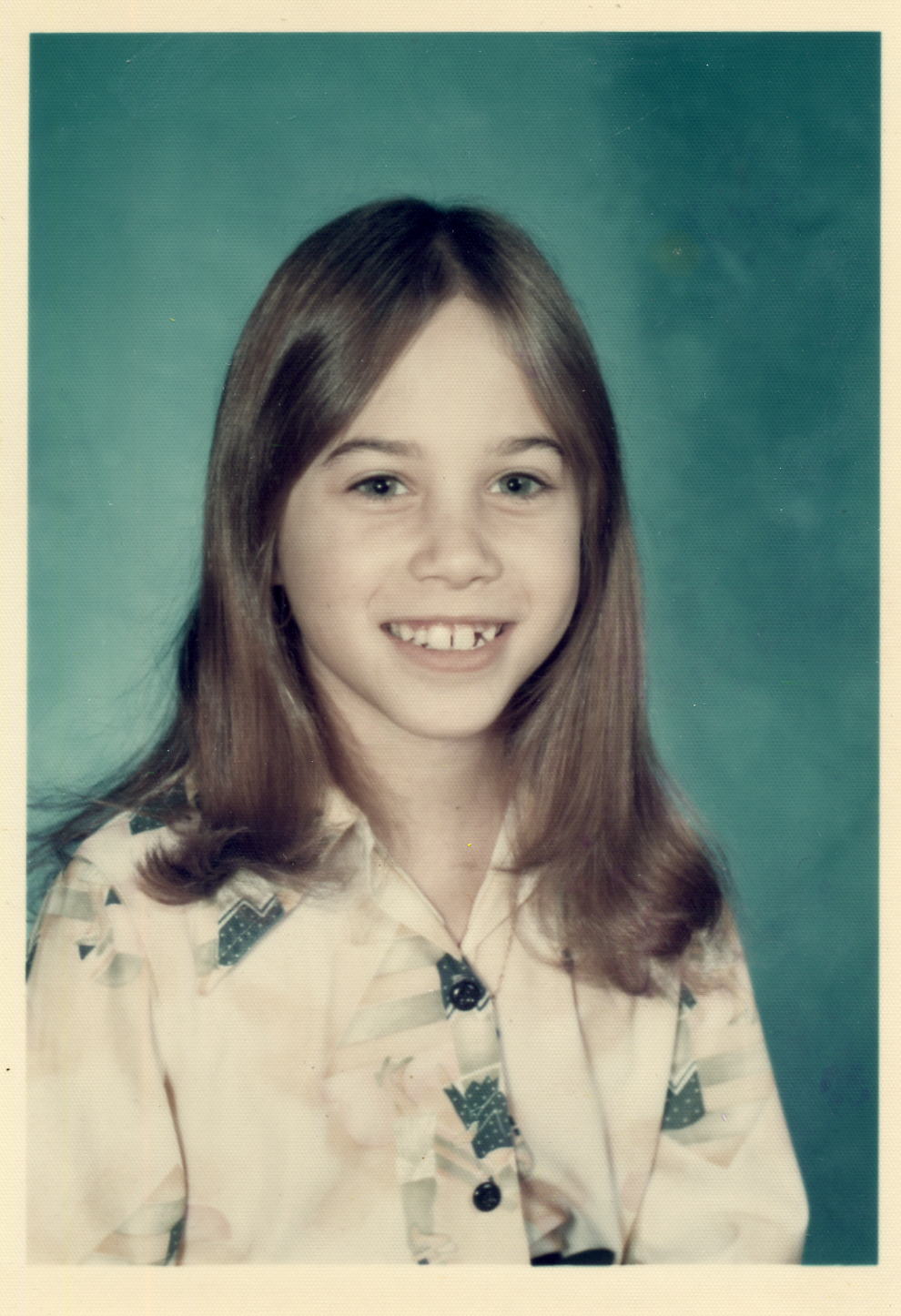 A young girl smiling in a school portrait