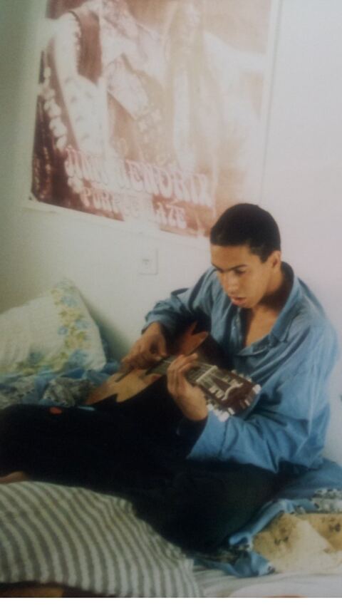 Kfir as a teenager with a guitar